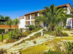 a house with a garden and a pond in front of it at Stunning Lagos Villa 10 Bedrooms Villa Lacuna Deluxe Private Pool and Jacuzzi Algarve in Lagos