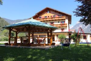 a large gazebo in front of a building at Hotel Galeno in Auronzo di Cadore