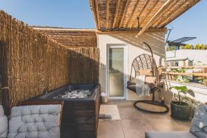 patio con bañera de hidromasaje y valla en Luxury Apartment with Acropolis View Terrace and Jacuzzi - Living Stone Moonstone, en Atenas