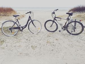 two bikes parked in the sand on the beach at Dom Kawalera in Kadyny