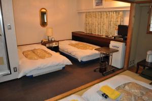 Postel nebo postele na pokoji v ubytování Hotel Los Inn Kochi