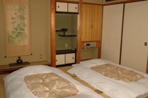 Postel nebo postele na pokoji v ubytování Hotel Los Inn Kochi