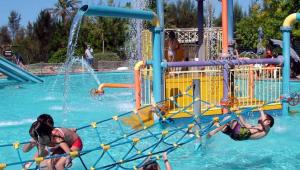 a group of people playing in a water park at Remanso Apart Hotel in Termas del Daymán