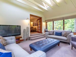 a living room with a large flat screen tv at The Old Boathouse in Cromdale