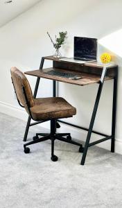 a desk with a laptop computer on top of it at Cosy One Bedroom Apartment in Trowbridge