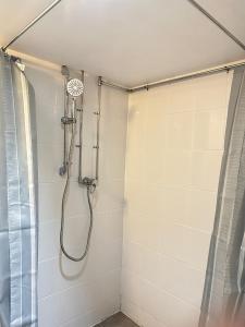 a shower in a bathroom with a shower curtain at Cosy One Bedroom Apartment in Trowbridge