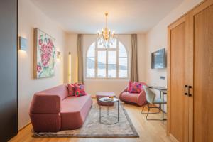 a living room with a couch and chairs and a table at Villa Waldkönigin in San Valentino alla Muta