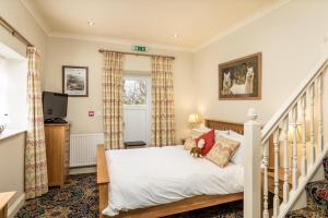 a bedroom with a bed and a staircase at Ffarm Country House in Abergele