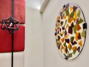 a mirror hanging on a wall next to a lamp at Best Western Plus Sabaudia Hotel in Sabaudia