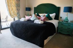 a bedroom with a large bed with towels on it at Tankardstown House in Slane