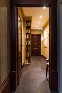 a hallway with a book shelf and a door at Florence Prestige Apartments ZANOBI 55 in Florence