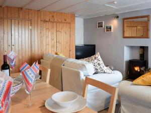 a living room with two white couches and a table at Seadrift in New Quay