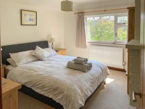 a bedroom with a bed with a towel on it at Llwyn Onn in Newchurch