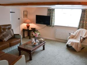 a living room with a couch and a coffee table at The Brambles in Horning
