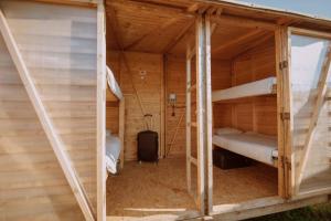ajar view of a wooden cabin with bunk beds at Glamping Ringrast in Spielberg