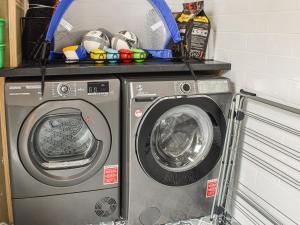 a washing machine and a dryer in a room at Church View - Ukc5700 in Castletown