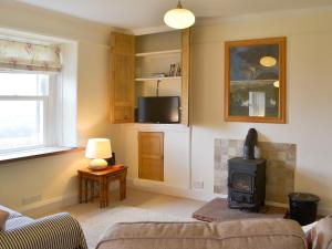 a living room with a couch and a stove at Load Pot in Watermillock