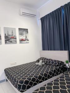 a bedroom with a bed with a blue curtain at Le Thompson - Puchong Center IOI Mall in Puchong