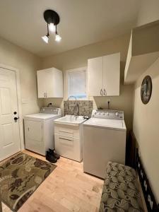 a kitchen with white appliances in a room at The Wonderland Cottage in Haliburton