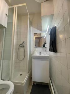 a bathroom with a shower toilet and a sink at Dream Dwell Paris-Charming Studio superb location in 7th district Paris in Paris