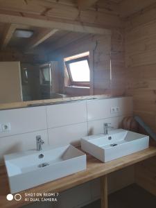 a bathroom with two sinks and a mirror at Felsenlandblick in Dahn