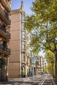 an empty street in a city with tall buildings at Urbany Hostel BCN GO! in Barcelona
