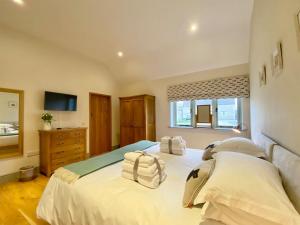 a bedroom with a large bed with towels on it at Tull - Uk4270 in Dyrham