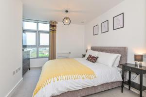 a bedroom with a large bed and a window at CannySuite in London