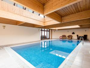 an indoor pool with a wooden ceiling at Piperdam House in Lundie