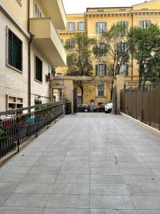 an empty sidewalk in a city with buildings at Venere Luxury Guest House in Rome