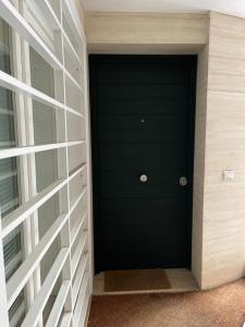 a black door on the side of a building at Venere Luxury Guest House in Rome