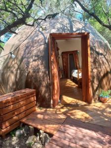 a doorway to a yurt with a bed in it at Domo Cielos del Uritorco in Capilla del Monte