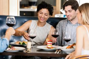 a group of people sitting at a table eating food and drinking wine at Hyatt Regency Mexico City Insurgentes WTC in Mexico City