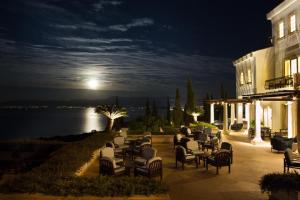 a group of chairs and tables on a patio at night at Anassa in Polis Chrysochous