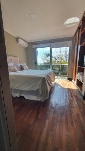 a bedroom with a bed and a large window at Departamento Caseros in Salta