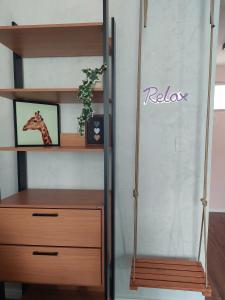 a book shelf with a giraffe picture on it at Relax Sampa in Sao Paulo