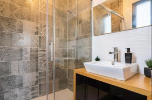 a bathroom with a sink and a shower at Villa des rives du Lac in Montans +51 photos