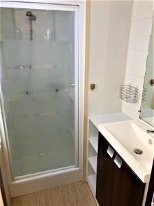 a bathroom with a glass shower and a sink at De Pujol Greenchalets Argeles sur Mer in Argelès-sur-Mer