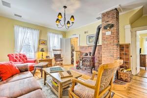 a living room with a couch and a brick fireplace at Historic Mount Holly Vacation Rental in Hortonville