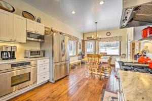 a kitchen with stainless steel appliances and a table with chairs at Historic Mount Holly Vacation Rental in Hortonville