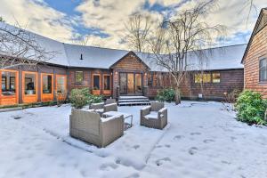 a house in the snow with two couches at Keene Villa Near Skiing, Swimming and Hiking! in Keene