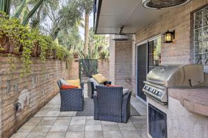 a backyard patio with chairs and a grill at Scottsdale Condo about 2 Mi to Downtown! in Scottsdale