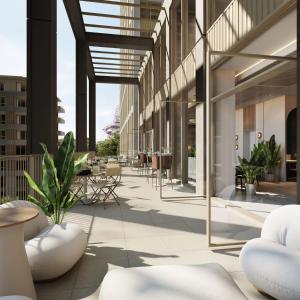 an internal courtyard of a building with tables and chairs at One and Two Bedroom Apartments at Coppermaker Square in Lively Stratford in London
