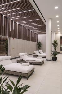 a row of pillows and tables in a lobby at One and Two Bedroom Apartments at Coppermaker Square in Lively Stratford in London