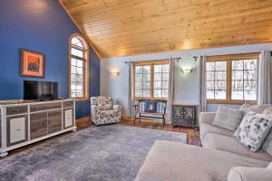 a living room with a couch and a tv at Secluded Ellsworth Apartment - Hiking Nearby! 