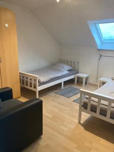 a room with a bed and a couch and a window at Ferienwohnung Lipp in Waldstetten