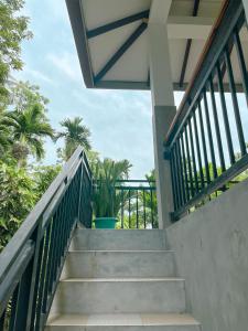 a staircase leading up to a house with palm trees at Tropical Vibes - Kathaluwa in Ahangama