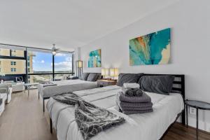 a bedroom with two beds and a living room at oceanside inn in Daytona Beach