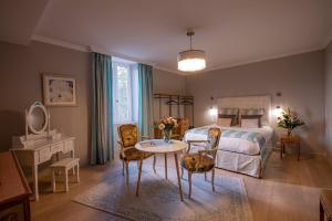 1 dormitorio con 1 cama, mesa y sillas en Maison Toscane in a remarkable village - heated pool, jacuzzi, billiard & ensuite luxury bedrooms en Terraube