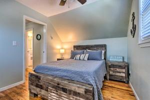 a bedroom with a large bed with a wooden headboard at Serene Pensacola Vacation Rental with Gas Grill in Pensacola